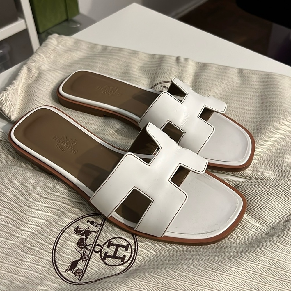 Hermes Oran sandals in white.